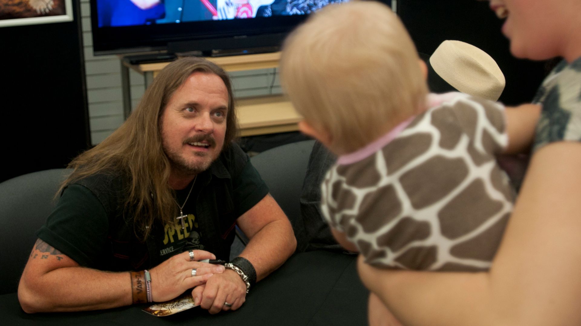 Johnny Van Zant, lead singer for the southern rock band Lynyrd Skynyrd, meets someone who could be his youngest fan during the band's visit to the Fort Jackson, S.C., Post Exchange, Aug. 22. When asked about having and meeting young fans still in single d