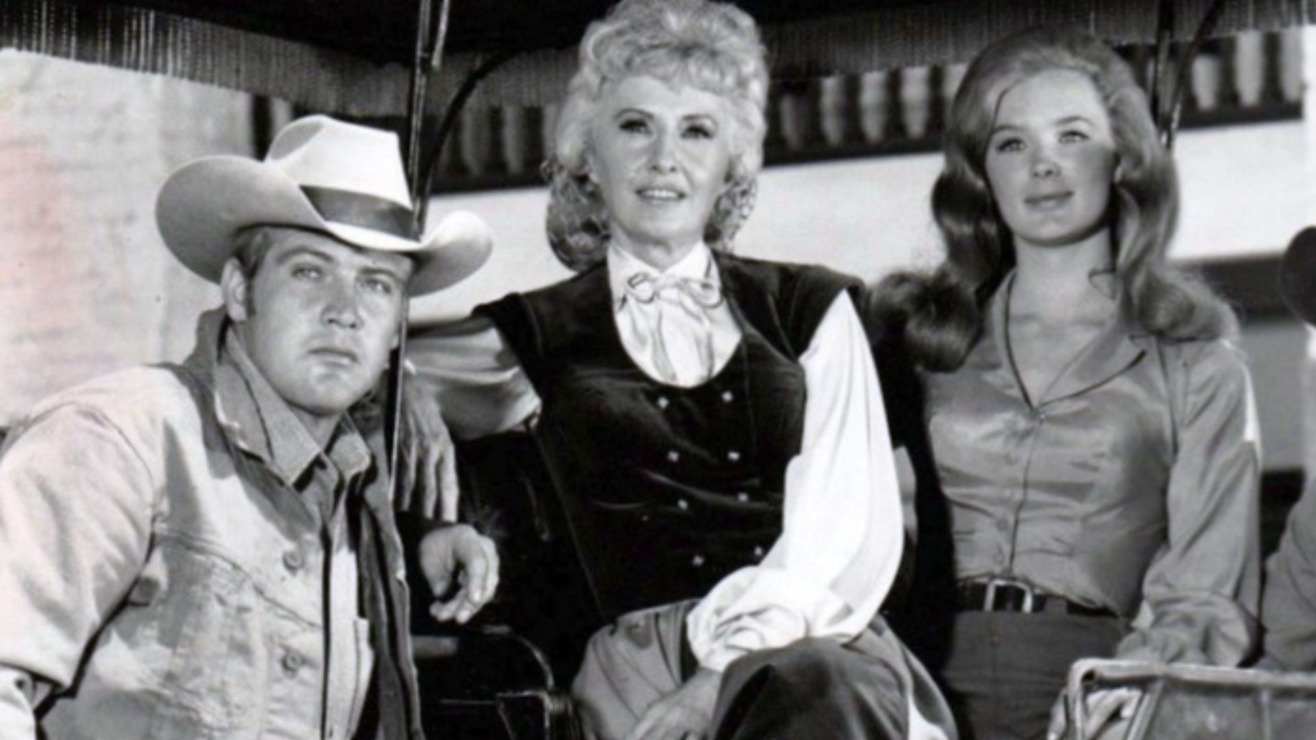 Cast photo from the television program The Big Valley.  From left: Lee Majors (Heath Barkley), Barbara Stanwyck (Victoria Barkley), Linda Evans (Audra Barkley), Charles Briles (Eugene Barkley).  Briles' character appeared only a few times in the first sea