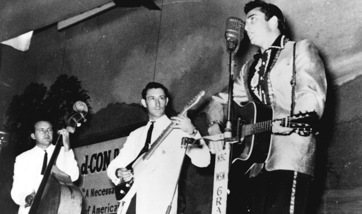 Country singer Johnny Cash performs on the WSM Grand Ole Opry tour with his band the Tennessee Two which included bassist Marshall Grant and guitarist Luther Perkins in circa 1956