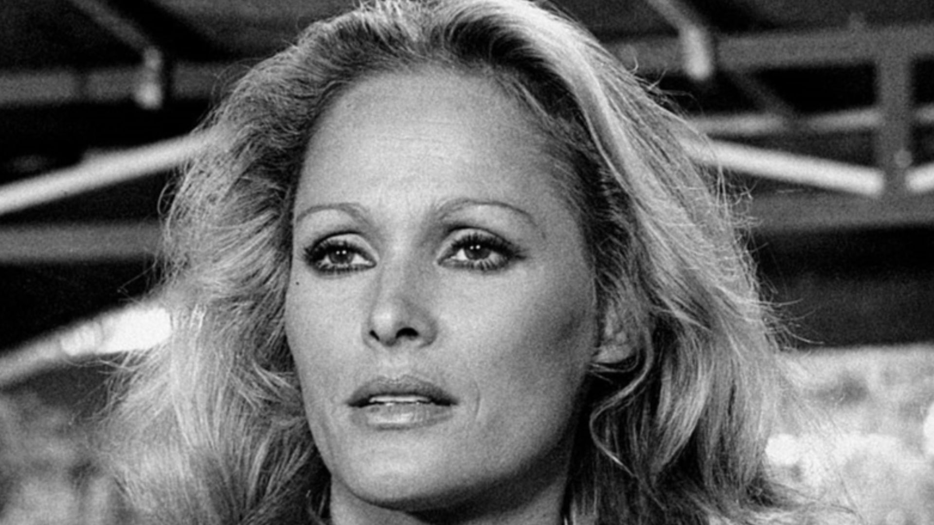 Close-up of Ursula Andress in a scene from the movie Stick'em Up, Darlings, starring the actress as the American hostess Nora Green. Italy, 1974