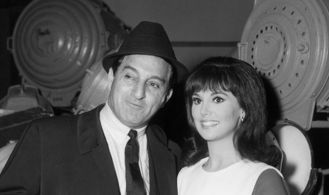  American actor Danny Thomas (1912 - 1991), holding a cigar, poses next to his daughter, actor Marlo Thomas, on the set of the television show, 'That Girl,' in which Marlo starred. 