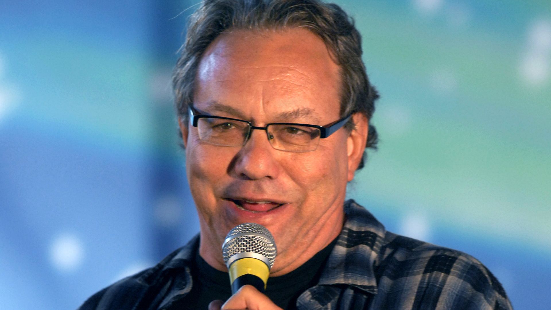 AVIANO AIR BASE, Italy-- Comedian Lewis Black performs as part of a USO holiday show held for the Aviano community, Dec. 22, 2007. Navy Adm. Michael G. Mullen, chairman of the Joint Chiefs of Staff, arrived in Aviano early Saturday afternoon from down ran