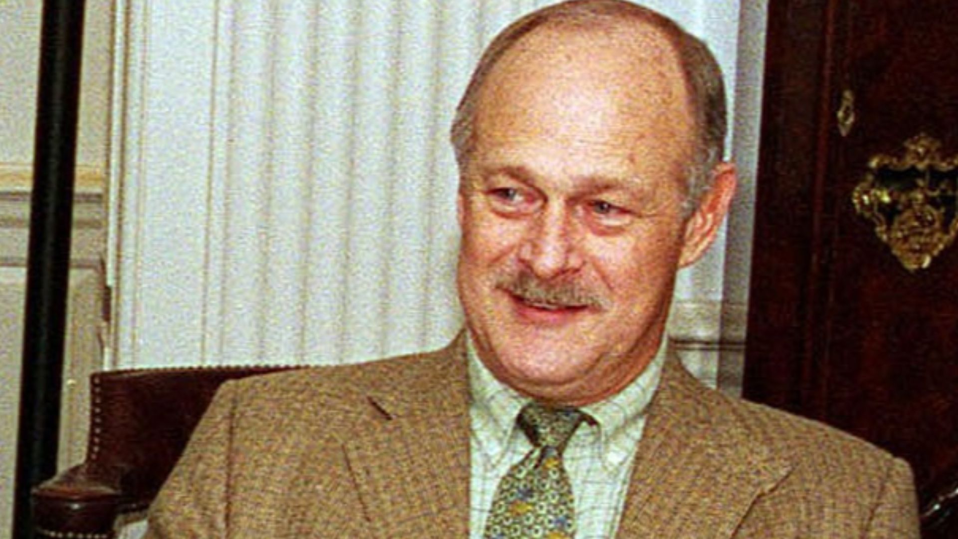 Gerald McRaney in meeting, but everything but McRaney is cropped out.Original description: Actor Gerald McRaney visits with Defense Secretary William S. Cohen in his Pentagon office