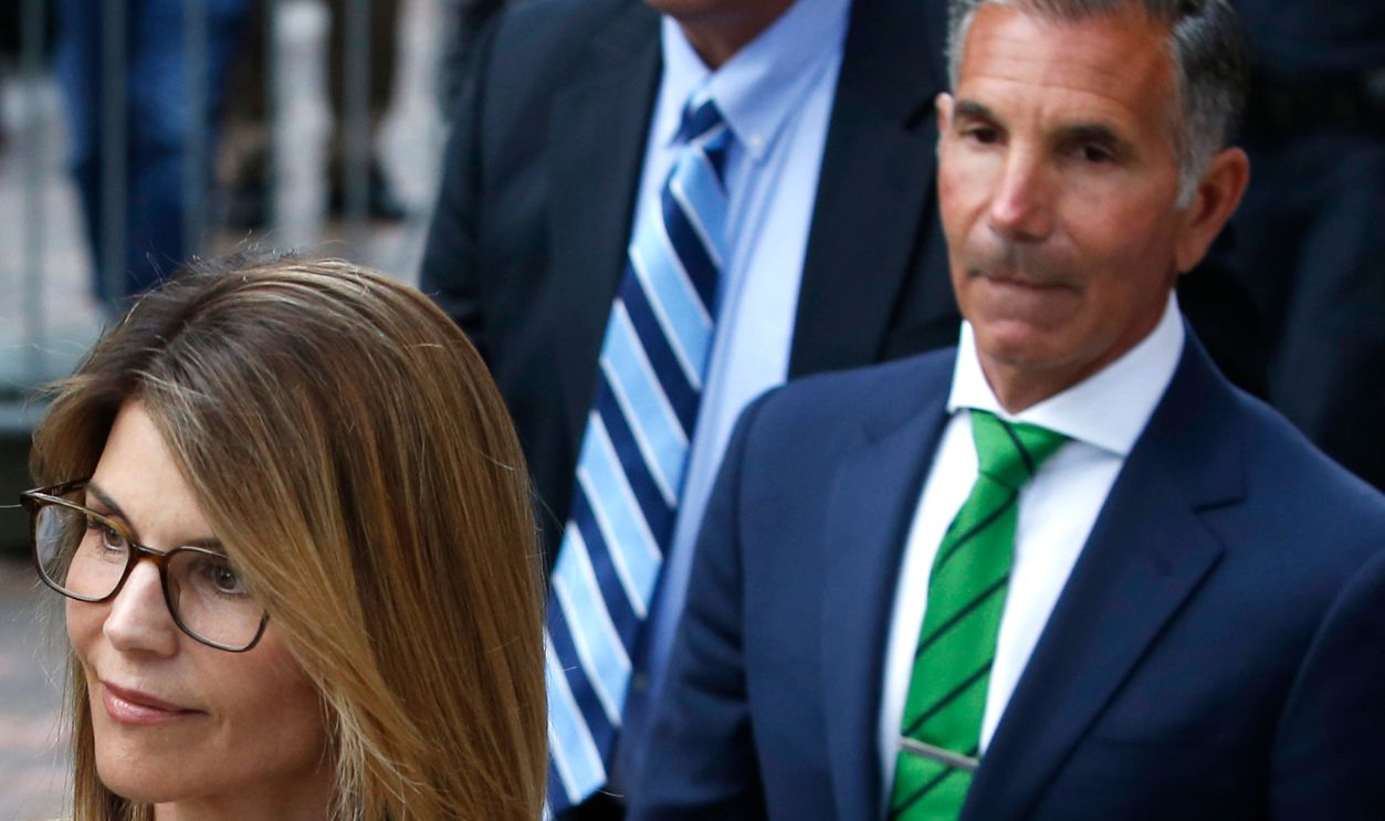 BOSTON, MA - APRIL 3: Actress Lori Loughlin, left, leaves as her husband Mossimo Giannulli, right, trails behind her outside of the John Joseph Moakley United States Courthouse in Boston on April 3, 2019. Hollywood stars Felicity Huffman and Lori Loughlin were among 13 parents scheduled to appear in federal court in Boston Wednesday for the first time since they were charged last month in a massive college admissions cheating scandal. They were among 50 people - including coaches, powerful financiers, and entrepreneurs - charged in a brazen plot in which wealthy parents allegedly schemed to bribe sports coaches at top colleges to admit their children. Many of the parents allegedly paid to have someone else take the SAT or ACT exams for their children or correct their answers, guaranteeing them high scores.