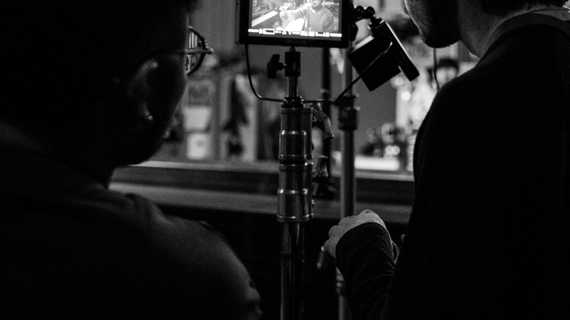 a man and a woman standing in front of a camera