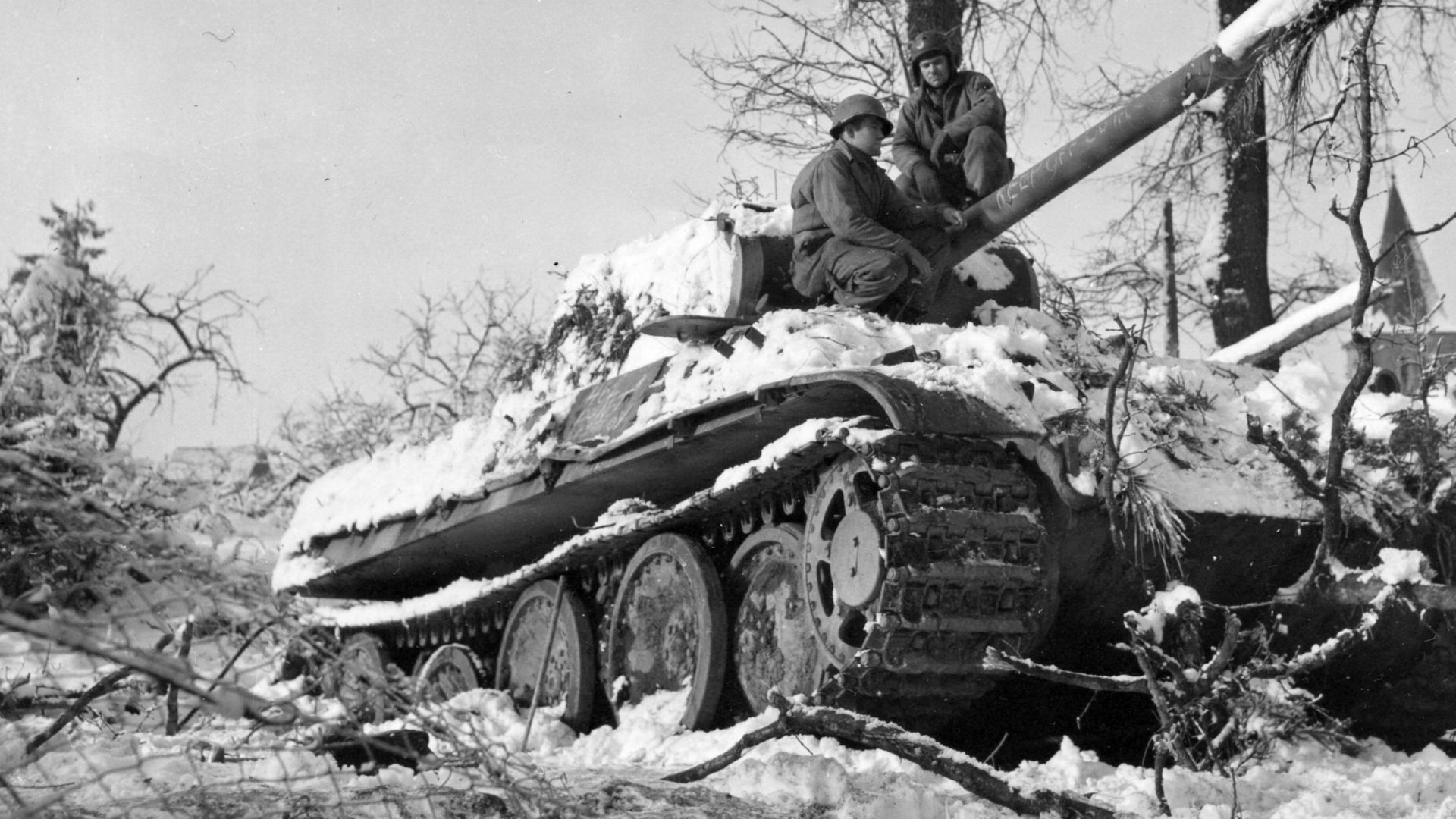 American soldiers inspect an abandoned German Panzer V Panther tank at Grandménil, Belgium, 4 January 1945. The description states that the tank was abandoned because of a jammed gun.