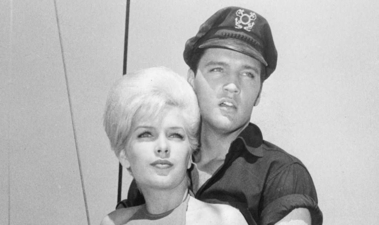 Stella Stevens and Elvis Presley on board and holding hands in a scene from the film 'Girls! Girls! Girls!', 1962