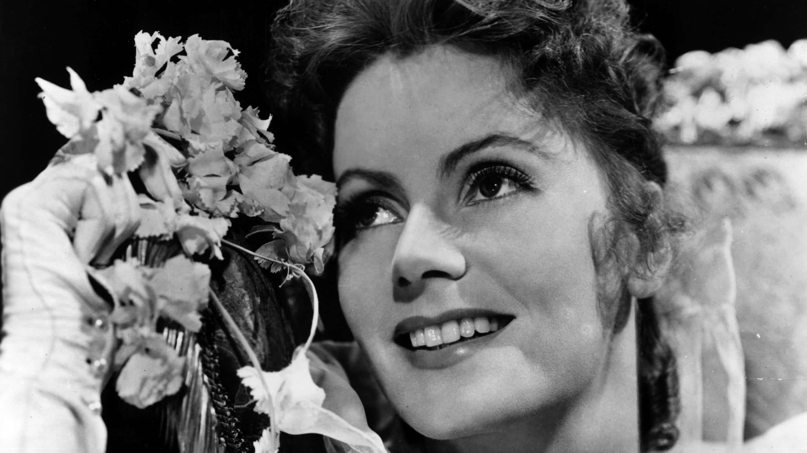 Greta Garbo holding flowers