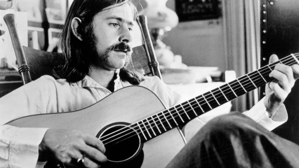 Norman Greenbaum playing on an acoustic guitar
