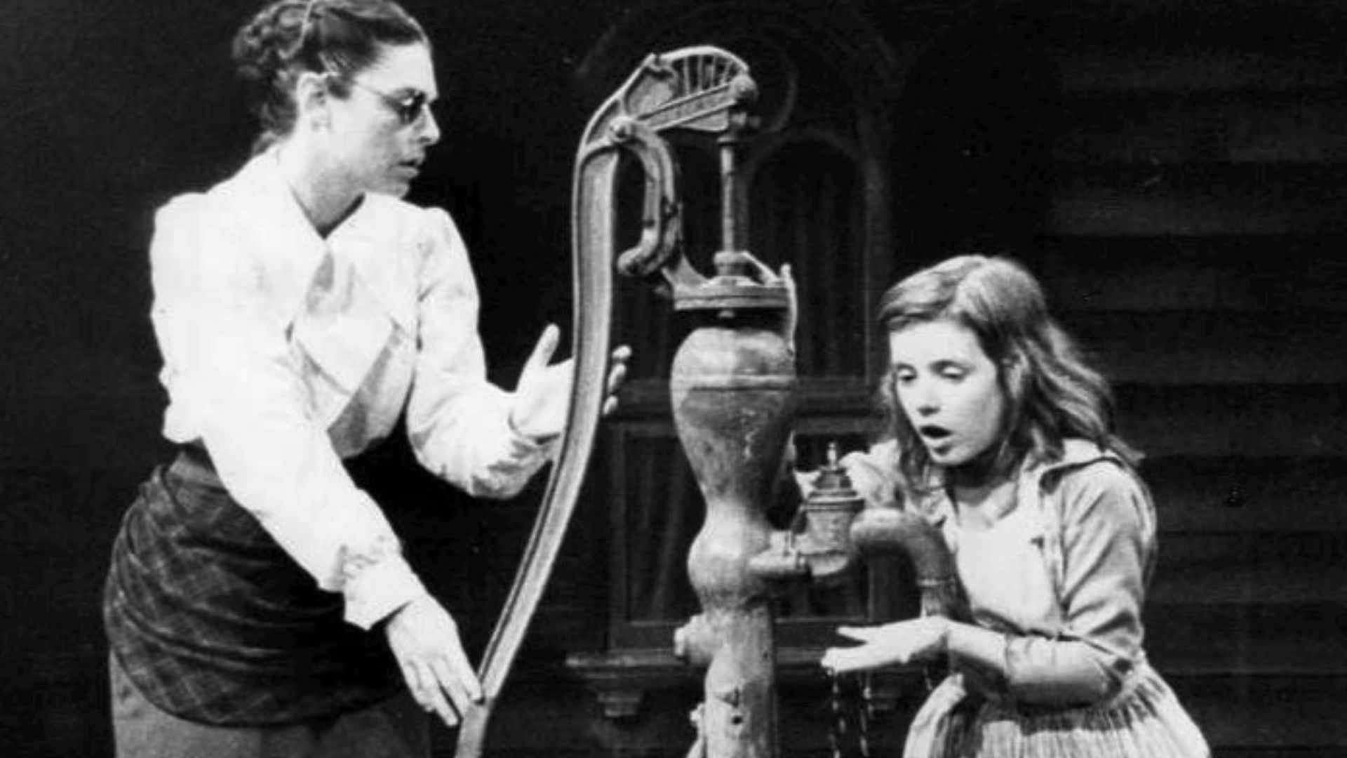Photo of Anne Bancroft as Annie Sullivan and Patty Duke as Helen Keller in the broadway play The Miracle Worker. In this scene, Miss Sullivan tries to teach Helen the meaning of