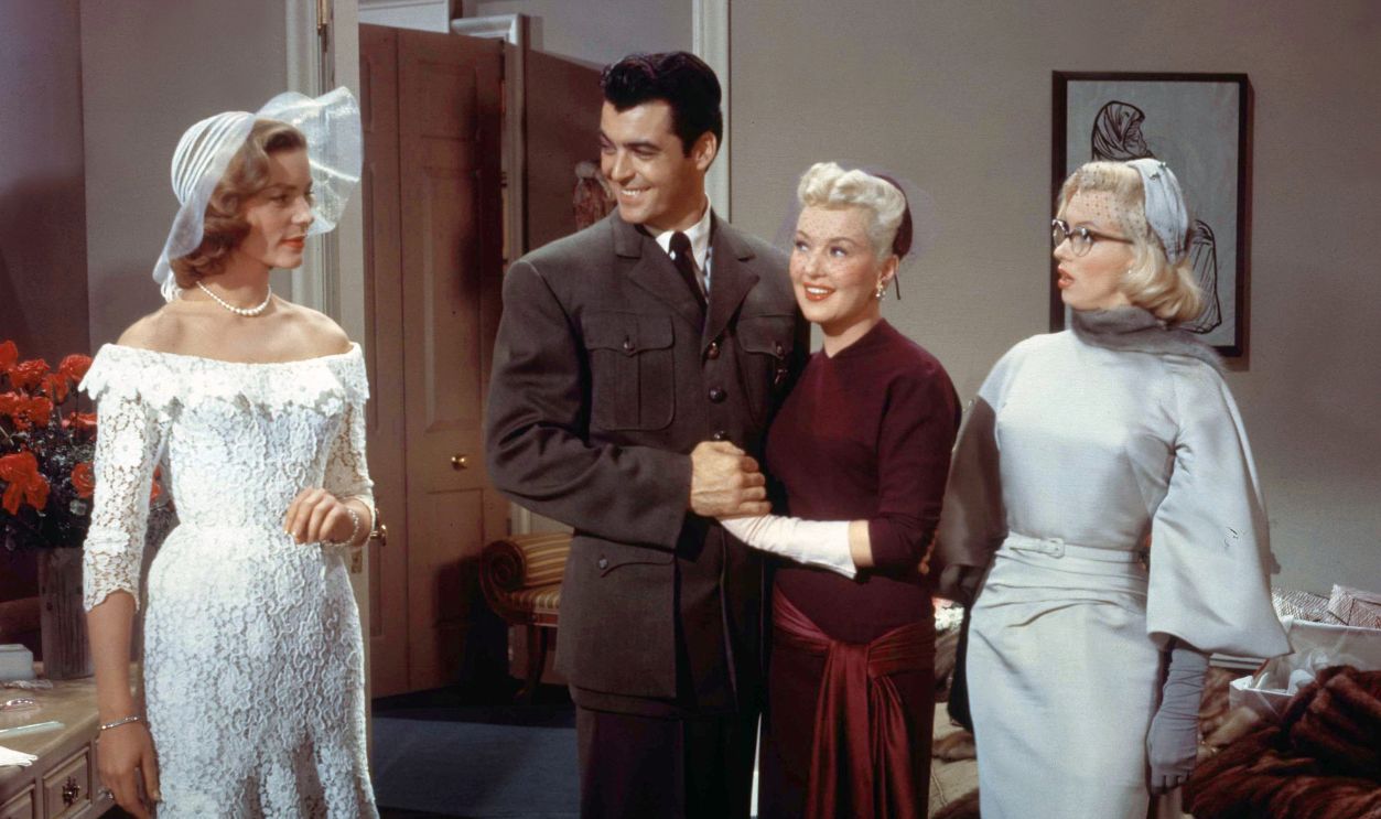 American actors Rory Calhoun, Lauren Bacall, Betty Grable and Marilyn Monroe on the set of How to Marry a Millionaire, directed by Jean Negulesco.
