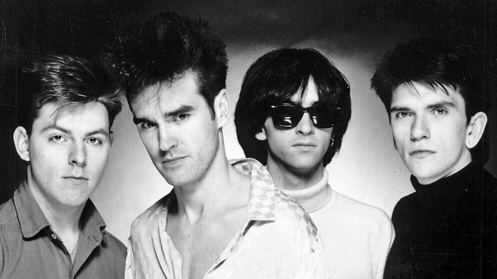 The Smiths in a promotional photograph for their debut album The Smiths, circa 1984. From left to right; Andy Rourke, Morrissey, Johnny Marr, and Mike Joyce. This photo was also issued later to promote their 1985 album Meat Is Murder.