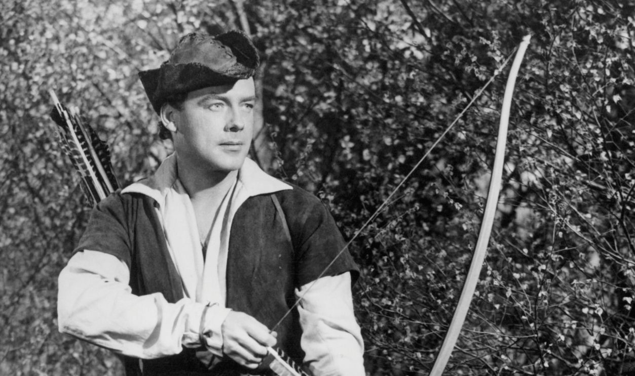 Richard Greene with a bow and arrow in a scene from the film 'The Adventures Of Robin Hood', 1955.