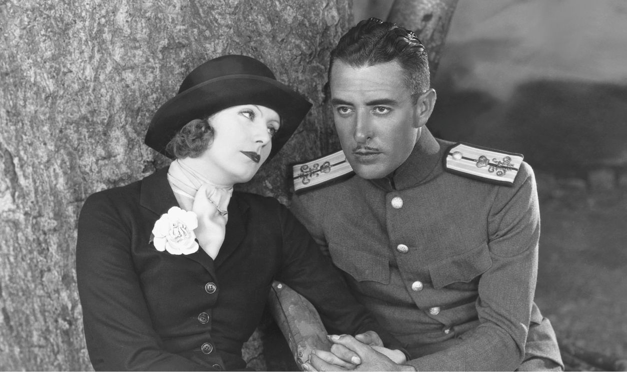 Actress Greta Garbo and actor John Gilbert on the set of 