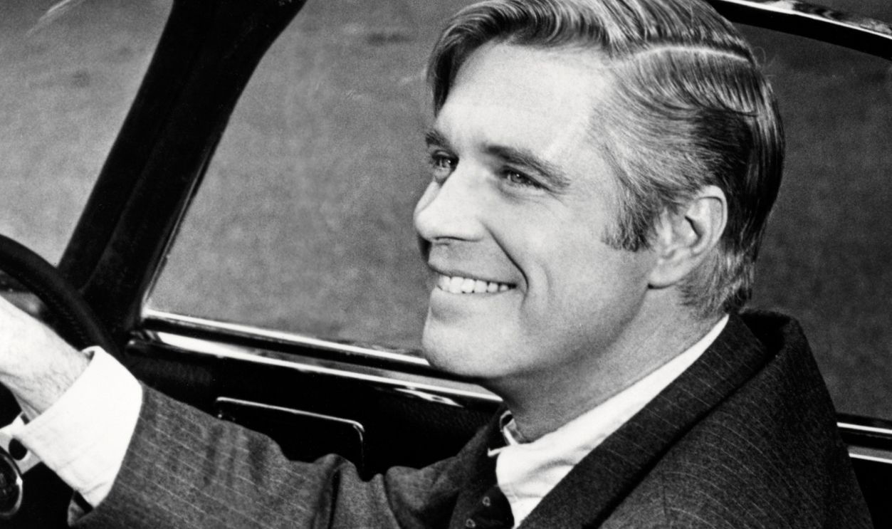 American actor George Peppard (1928 - 1994) as John Shay, at the wheel of a Lotus sports car in 'The Executioner', directed by Sam Wanamaker, 1970.