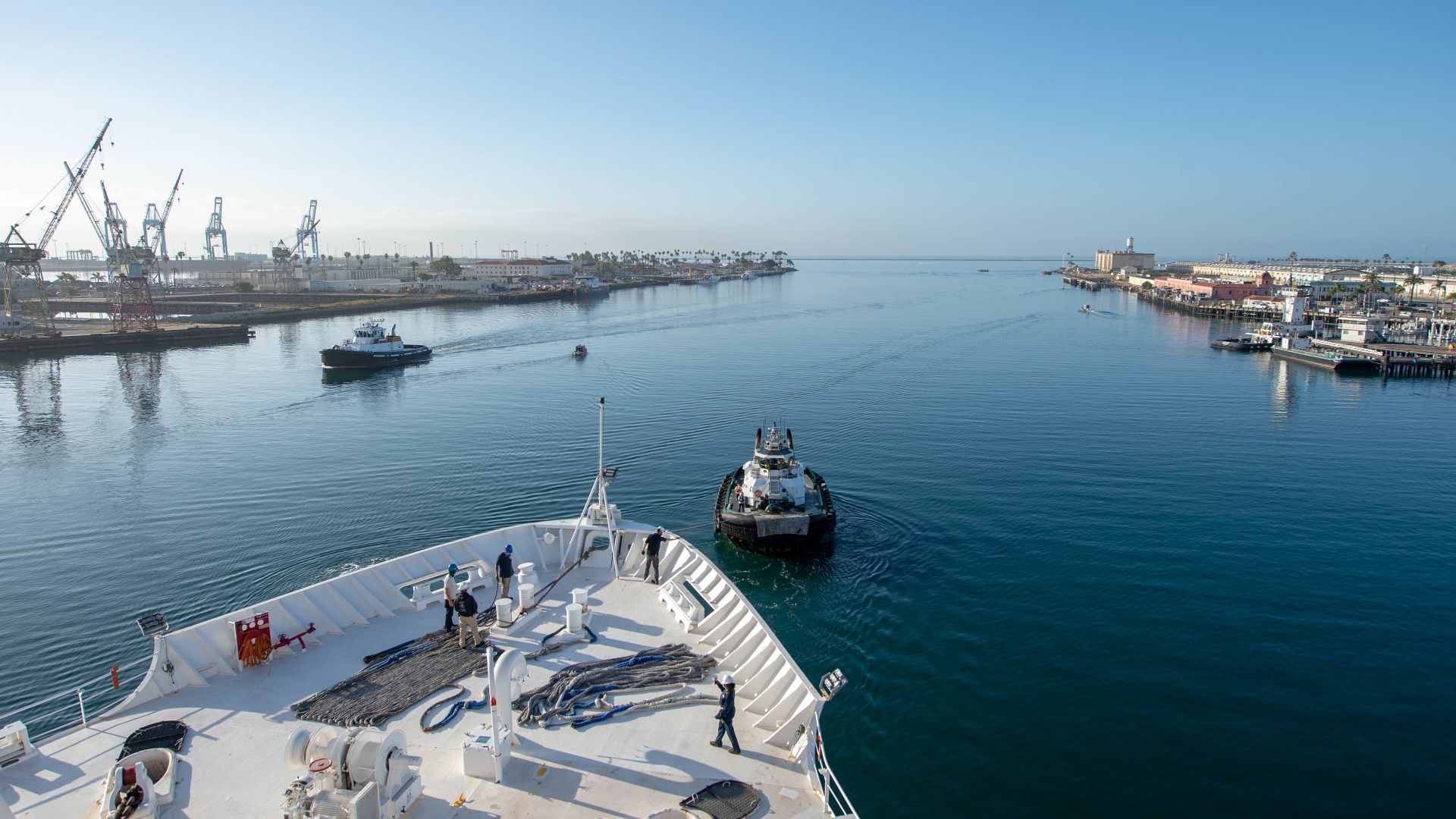 200515-N-VI515-1131 PORT OF LOS ANGELES (May 15, 2020) Military Sealift Command civilian mariners handle the lines aboard the hospital ship USNS Mercy (T-AH 19) as Mercy departs the Port of Los Angeles. Mercy deployed in support of the nation's COVID-19 r