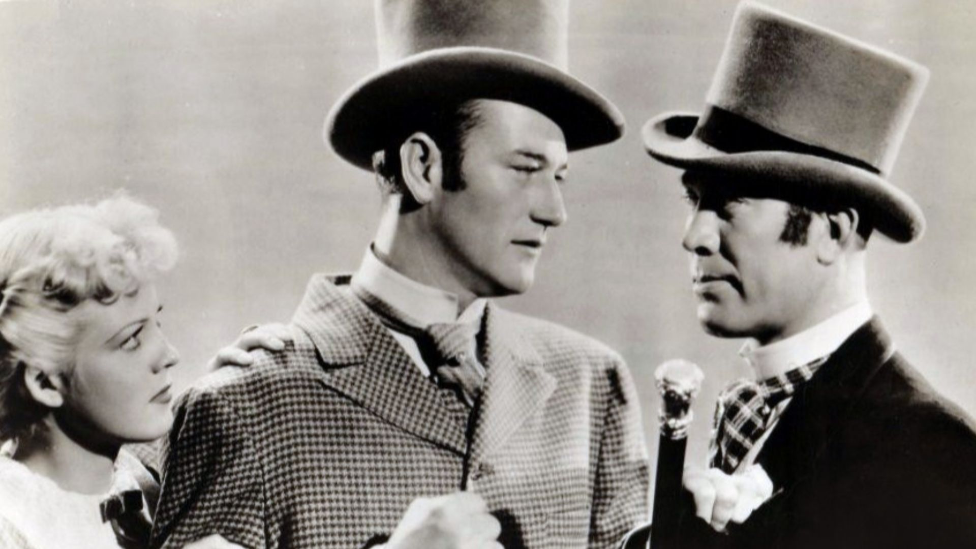 L. to R. : Jean Rogers, John Wayne & Ward Bond in Conflict - publicity still (cropped)