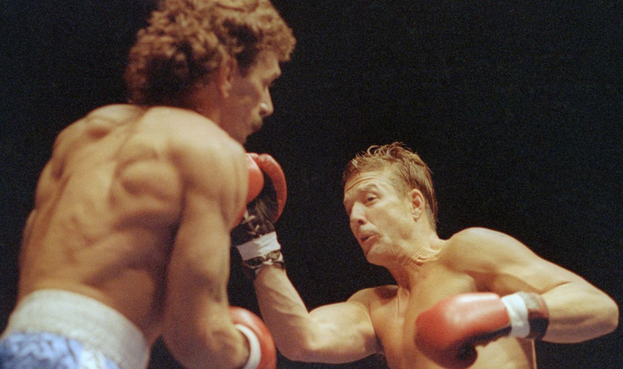 GettyImages - 515328978 - Actor Mickey Rourke lays into his opponent Steve Powell during fourth round action 5/23. Rourke won the fight in a unanimous decision in his first professional bout.