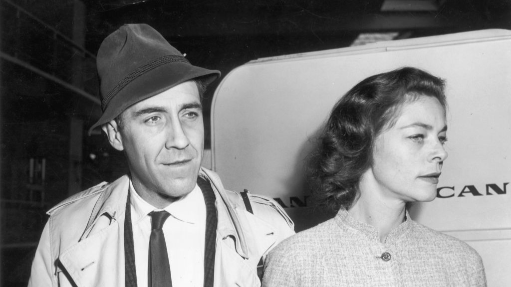 American actor Jason Robards, Jr. and his fiancee, American actor Lauren Bacall, pause at New York International Airport