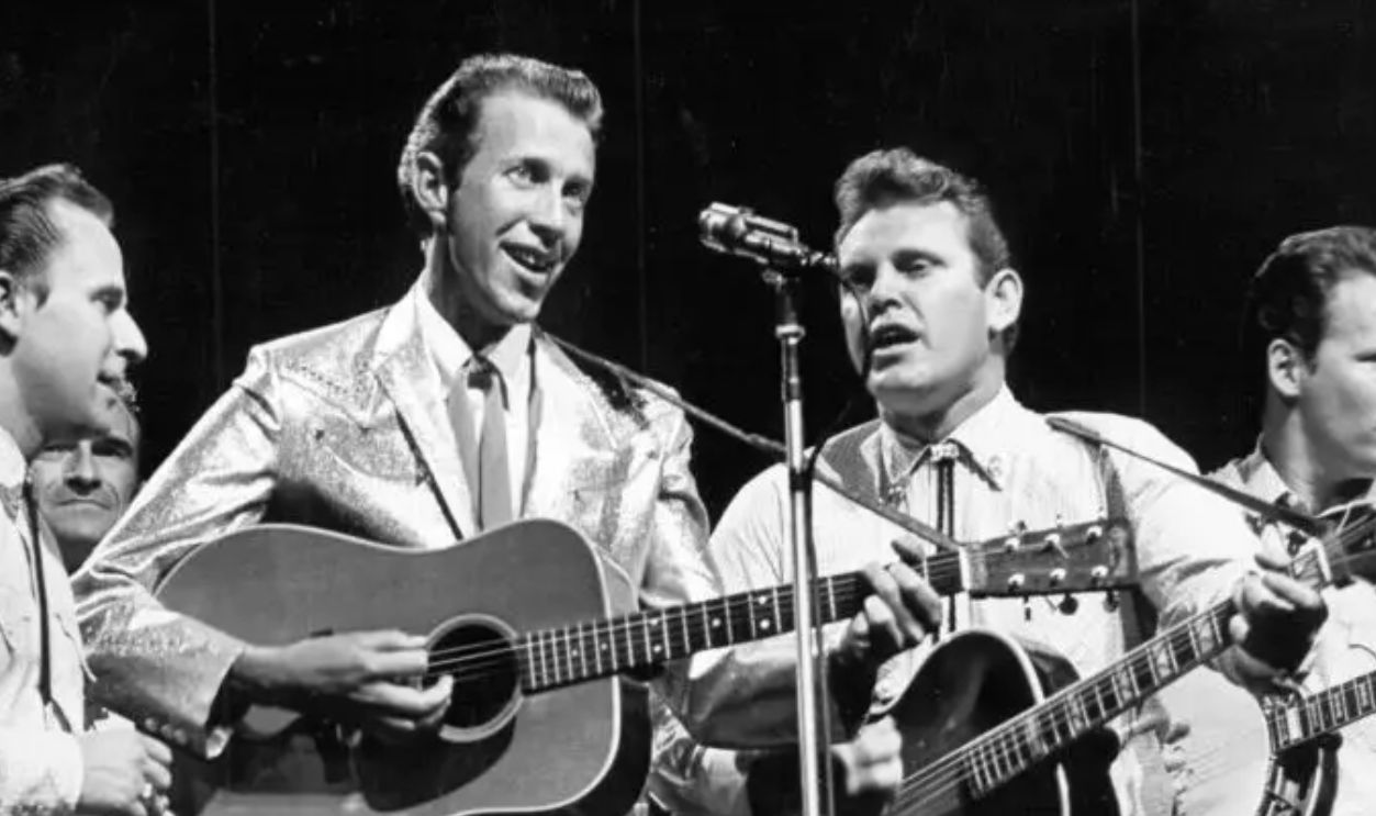 CIRCA 1965: Country singer Porter Wagoner plays a Martin acoustic guitar as he performs onstage with his band in circa 1965.