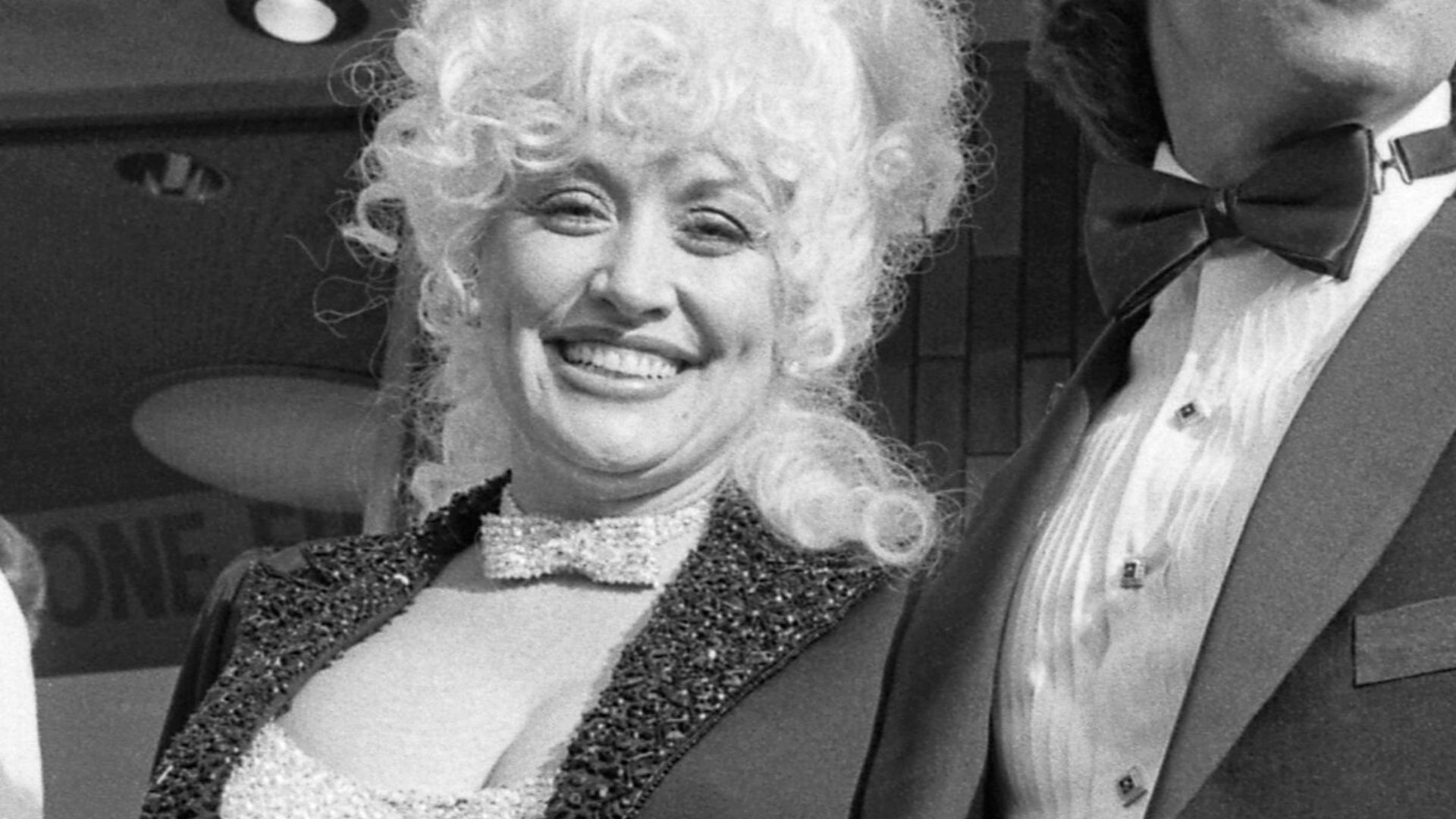 Dolly Parton and Sylvester Stallone arriving at benefit showing of their motion picture Rhinestone. Proceeds went to Los Angeles Chapter of the National Society for Children and Adults With Autism.