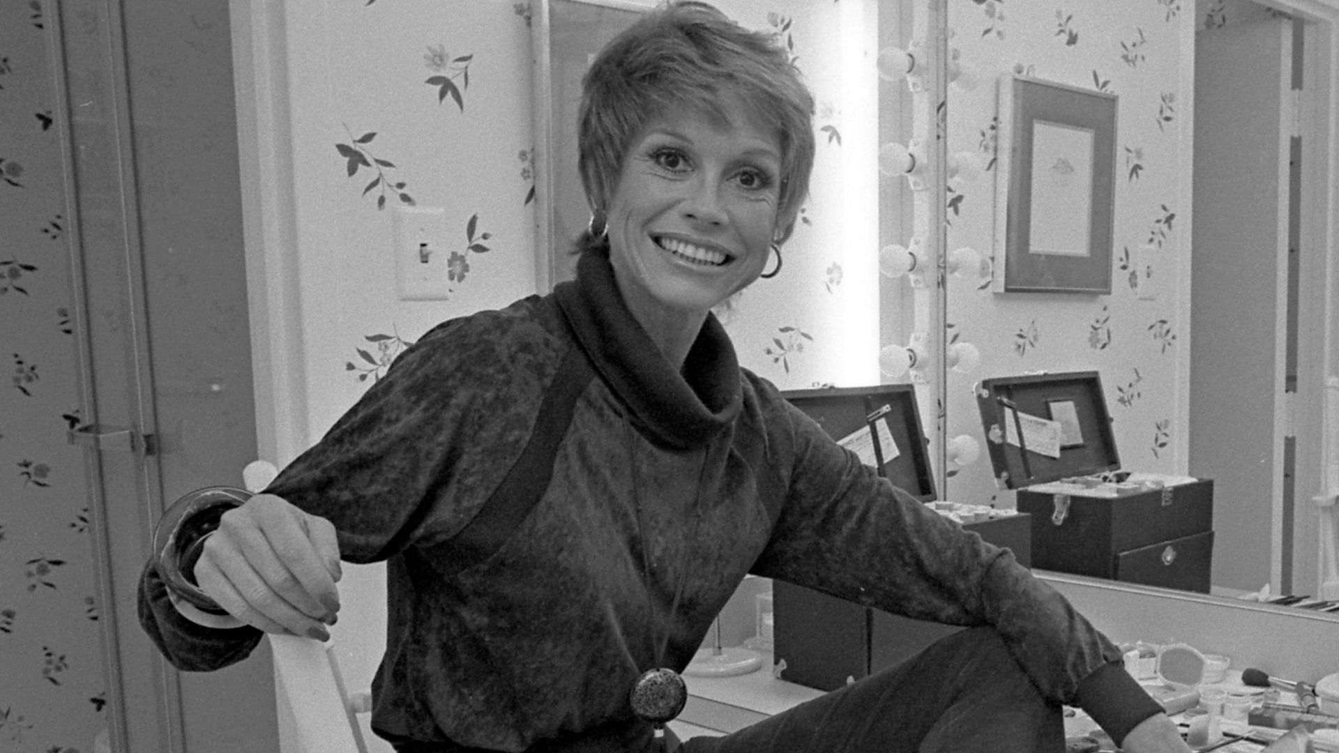Actress Mary Tyler Moore sitting before dressing table