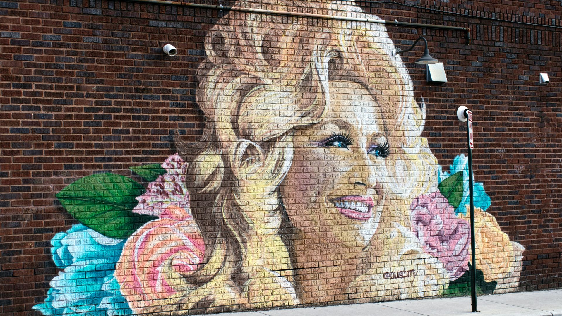 woman and girl painting on wall