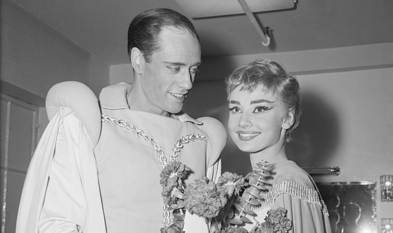 (Original Caption) Costars Audrey Hepburn and Mel Ferrer hold flowers backstage at the opening of the play Ondine, February 18th, at the 46th Street Theater. Presented by the Playwright's Company, Ondine is a romance written in 1938 by Jean Giraudoux.