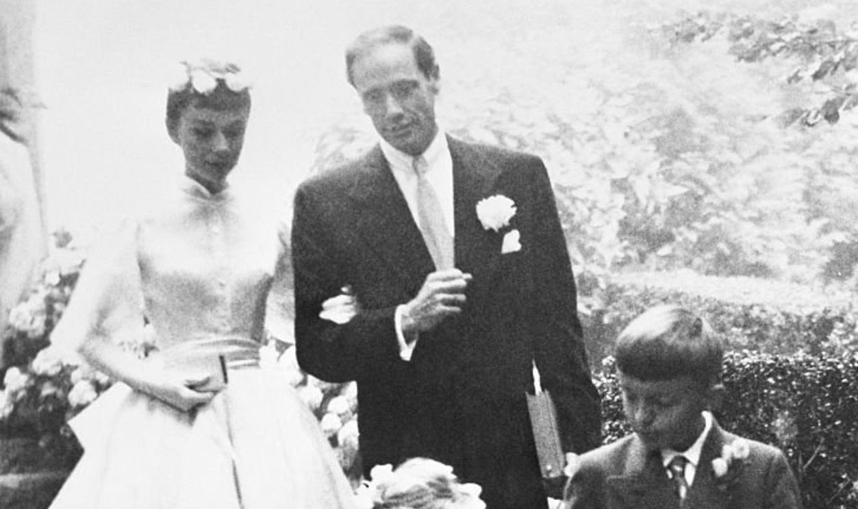 (Original Caption) Audrey Hepburn, 25, and Mel Ferrer, 37, leave the chapel after their wedding at Burgenstock Mountain, overlooking Lake Lucerne. The flower girl and page are the children of hotel owner Fritz Frey, whose resort has been the actress's retreat for about ten weeks. Ferrer flew in from Italy for the wedding, which was attended by the Bride's mother, the Dutch Baroness Ella Van Heemstra. A brief secret civil ceremony at Buochs, Switzerland preceded the ceremony.