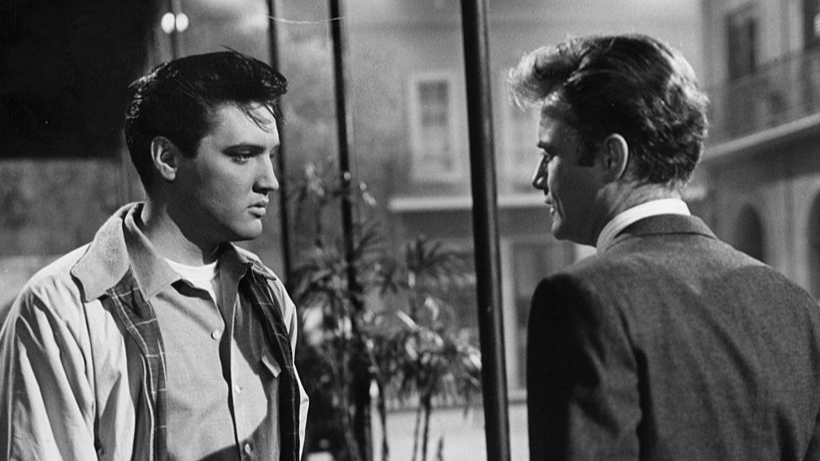 Elvis Presley meeting Vic Morrow outside in a scene