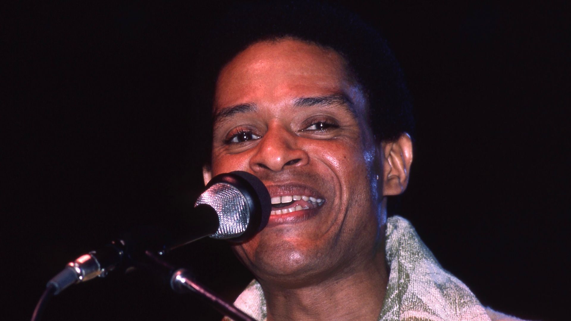 American singer Al Jarreau pictured during a concert at the Philipshalle in Düsseldorf, Germany, on January 16 1981. Scan of a Kodachrome 64 slide, taken by myself with Canon A1 and Canon FD 2.8/200 out of Hands.