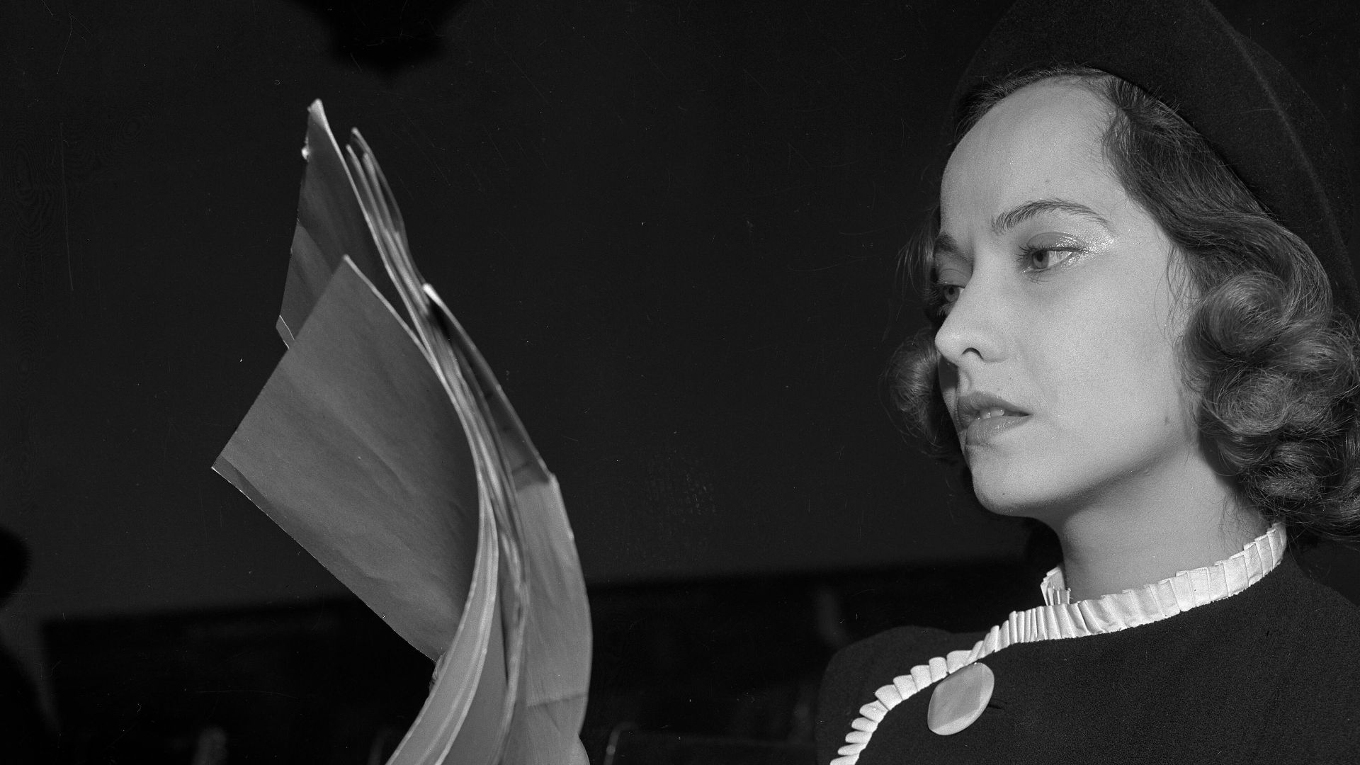 Actress Merle Oberon reviewing court papers in suit by her former attorney, Lyle W. Rucker