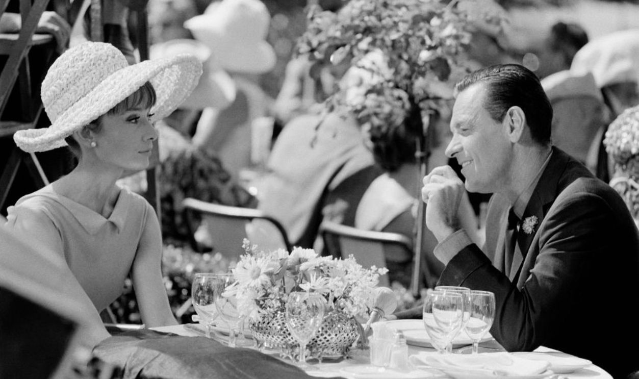 PARIS, FRANCE - 1963: Audrey Hepburn and William Holden during the shooting of movie 'Paris when it sizzles' directed by Richard Quine, 1963 in Paris, France. 