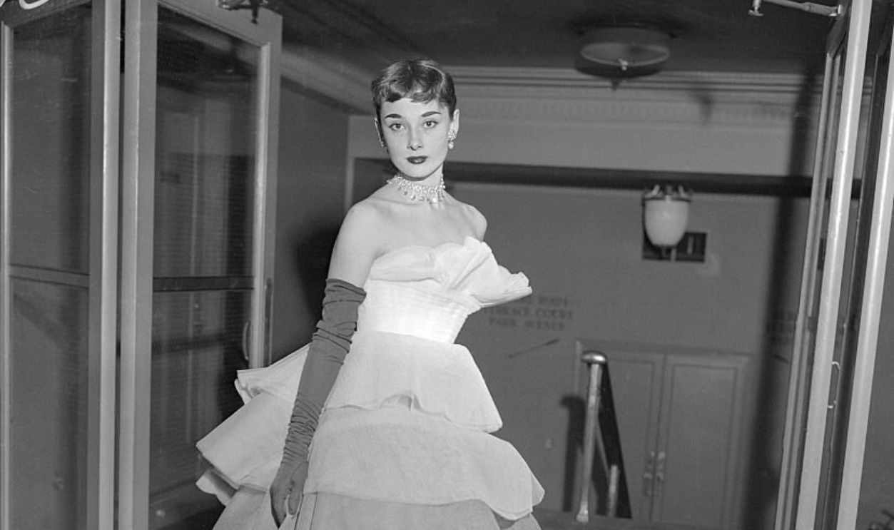 (Original Caption) Audrey Hepburn wearing a tiered ball gown of white net graduated in tones of pale grey to black at the March of Dimes Fashion Show in the Waldrof Astoria, New York City.