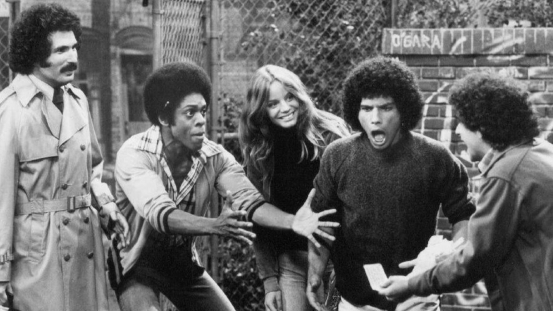 Publicity photo from the television program Welcome Back, Kotter. From left: Gabe Kaplan, Lawrence Hilton-Jacobs, Wendy Rastatter, Robert Hegyes, and Ron Palillo.  The Sweathogs are celebrating a winning New York State lottery ticket while Mr. Kotter look