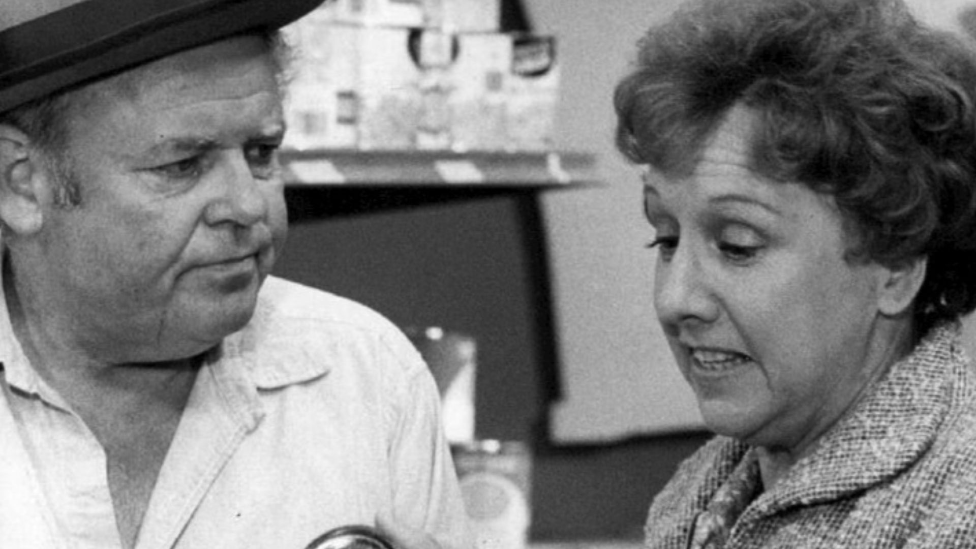 Photo of Carroll O'Connor and Jean Stapleton as Archie and Edith Bunker.  While on a layoff from the plant, Archie gets a lesson in the price of food when he accompanies Edith to the supermarket.