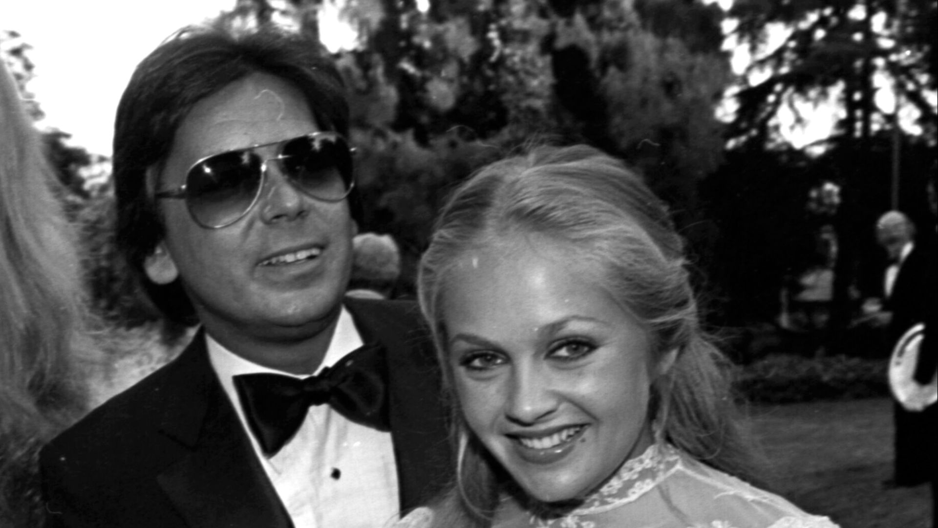 Jon Mercedes and Charlene Tilton at a lawn party at the Pickford Estate in Beverly Hills. The party was to honor Dr. Jerry Buss and was thrown by the Bravo Chapter of the City of Hope.