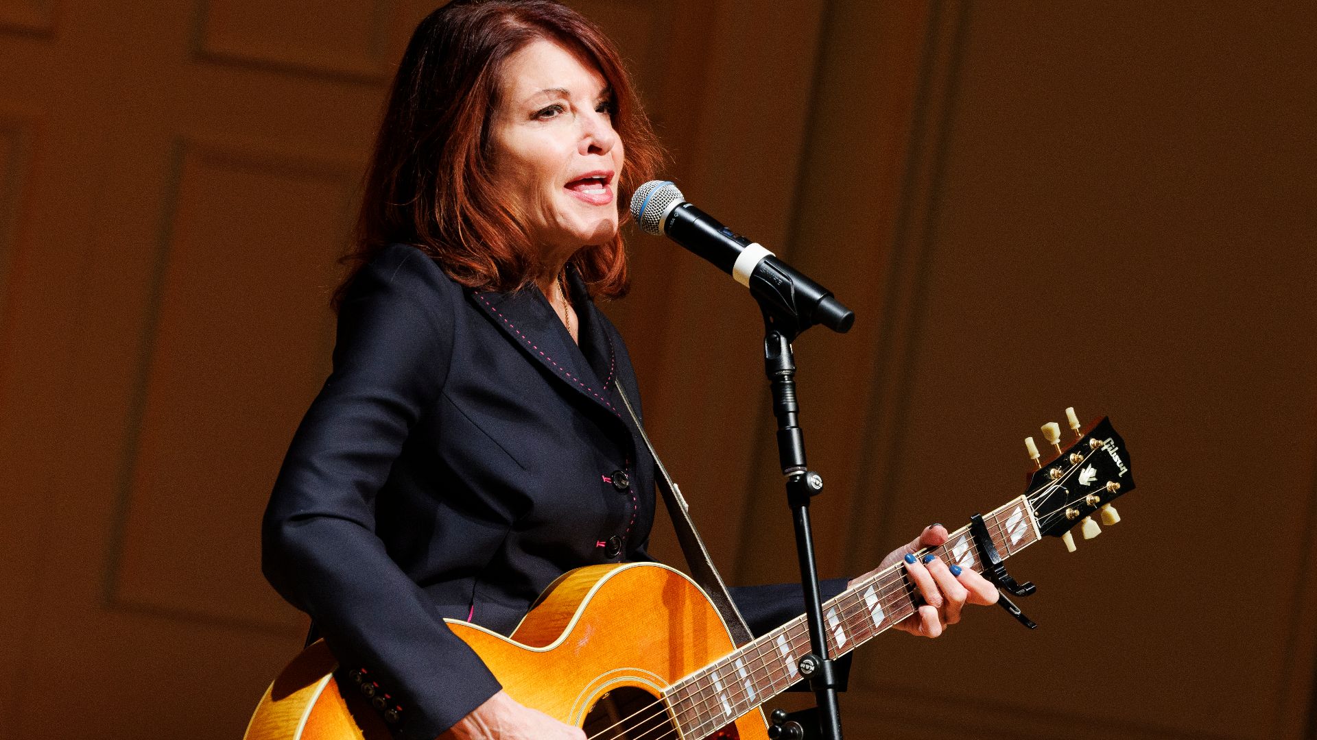 Rosanne Cash performs in the Coolidge Auditorium, November 24, 2025, during a memorial concert for Music Division Chief Sue Vita, who passed away earlier in the year. Photo by Shawn Miller/Library of Congress. 
Note: Privacy and publicity rights for indiv
