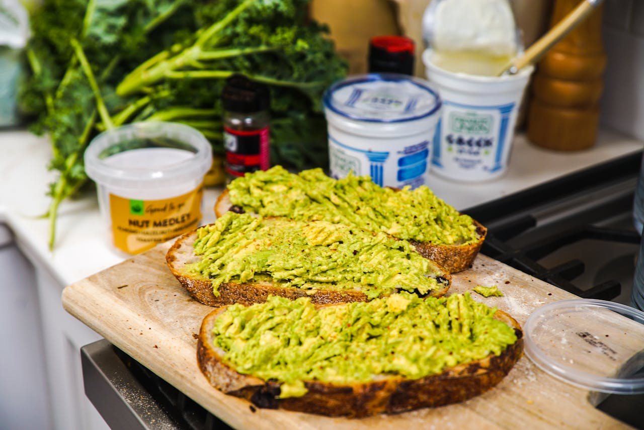 Close-up Photo of Avocado Toast Slices placed on a wooden plate
