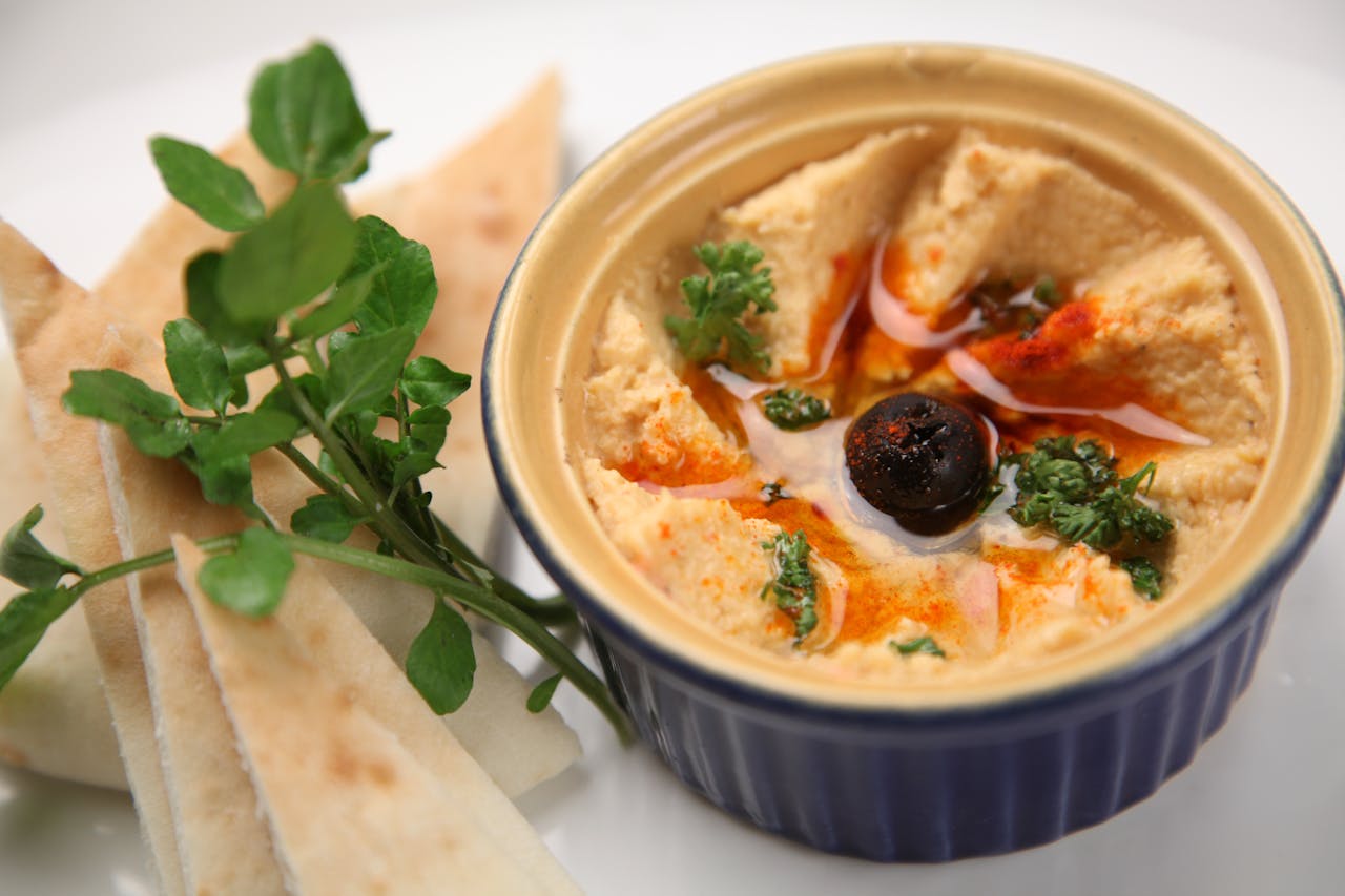Close-up Photo of Fresh Hummus And Pita Bread placed on a table