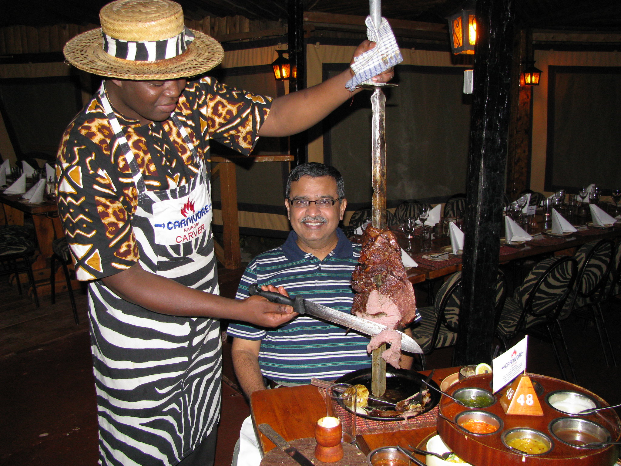 A carver serves ostrich meat at the Carnivore