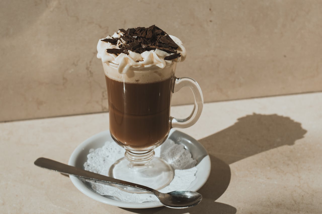 A Glass with Coffee with Whipped Cream and Chocolate on Top