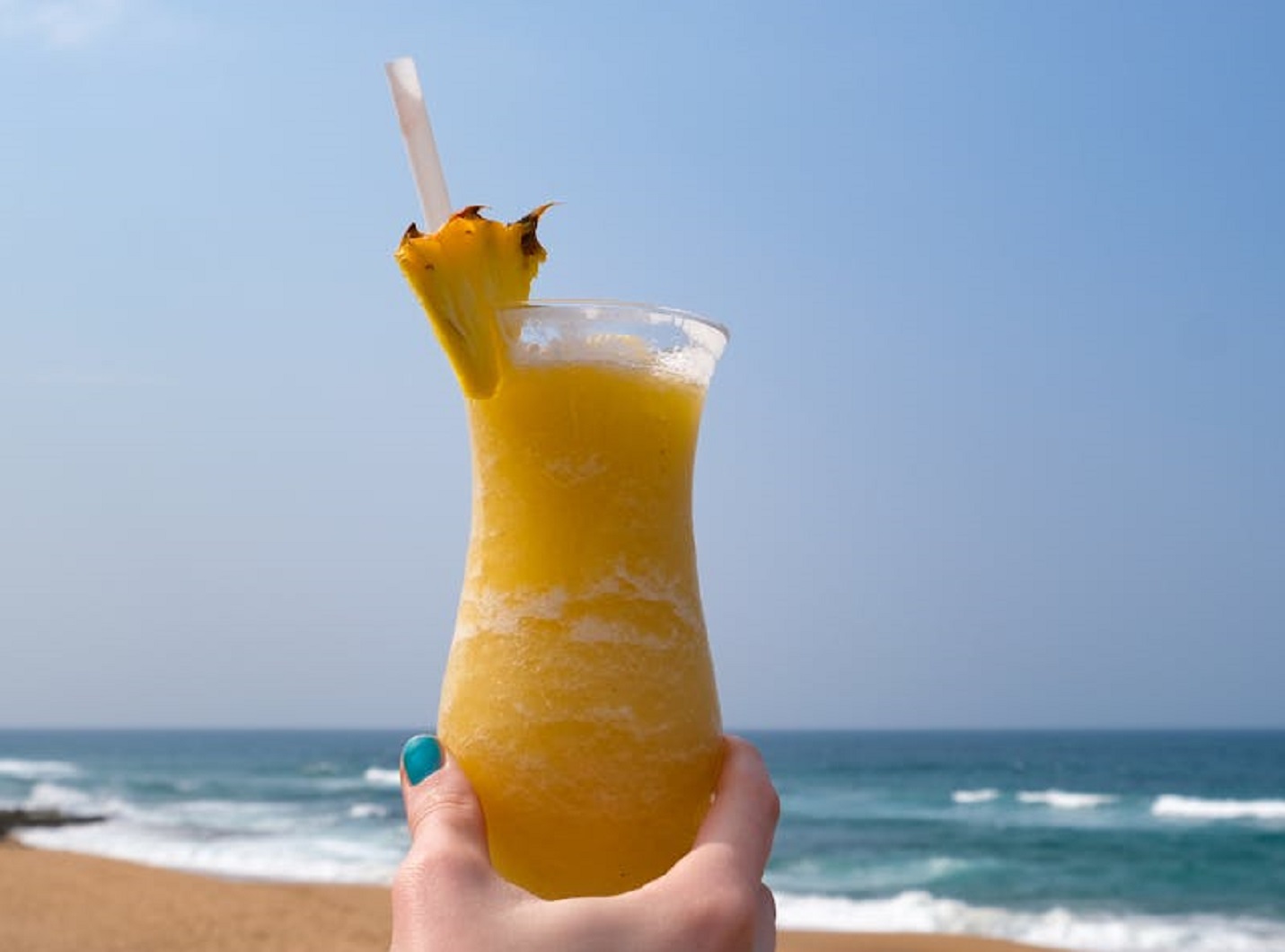 A Person Holding a Pineapple Cocktail