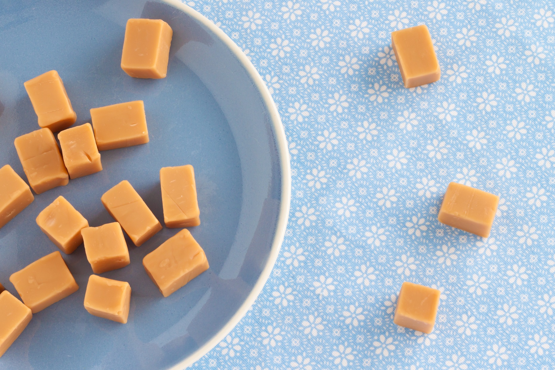 Top view of sweet caramel toffees, fudges on a plate