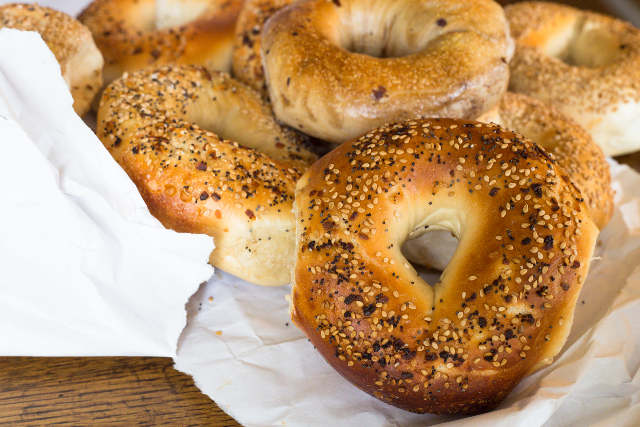 Bagels with seeds in a paper bag