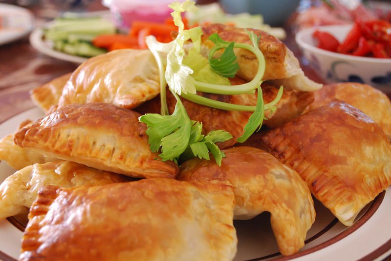 Close-up Photo of Curry Puffs on a white plate placed on  wooden table