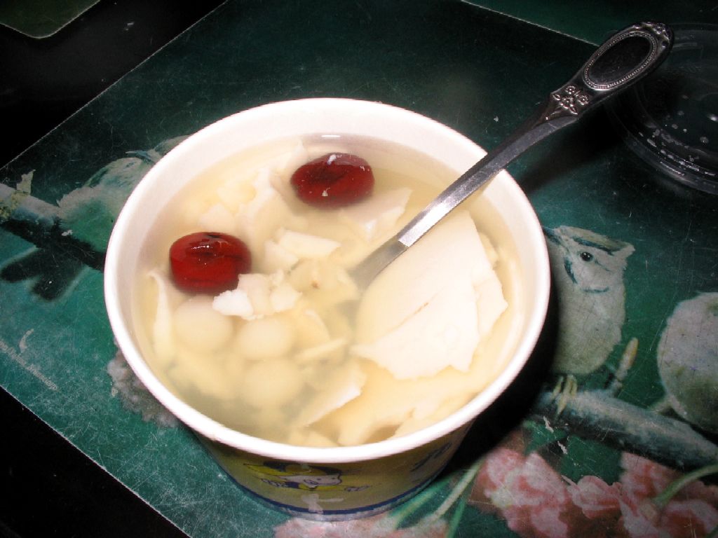 Close-up Photo of Douhua in a plastic bowl placed on a table