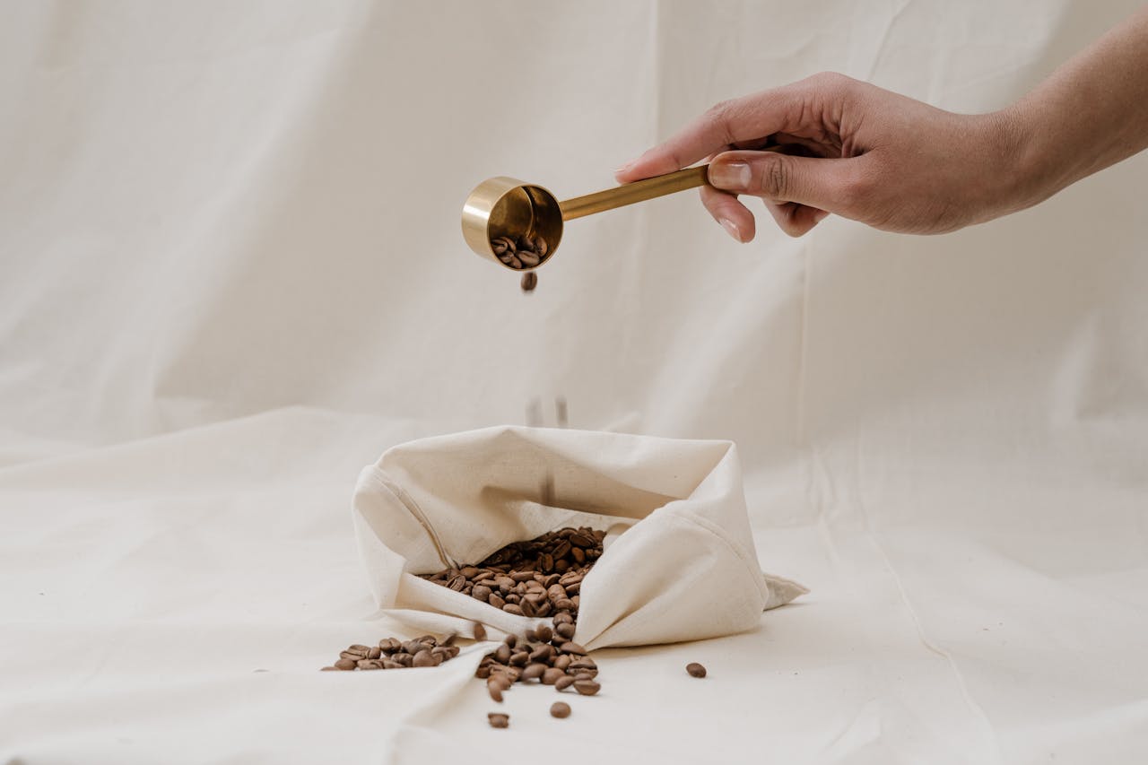 Person pouring coffee beans in a bag