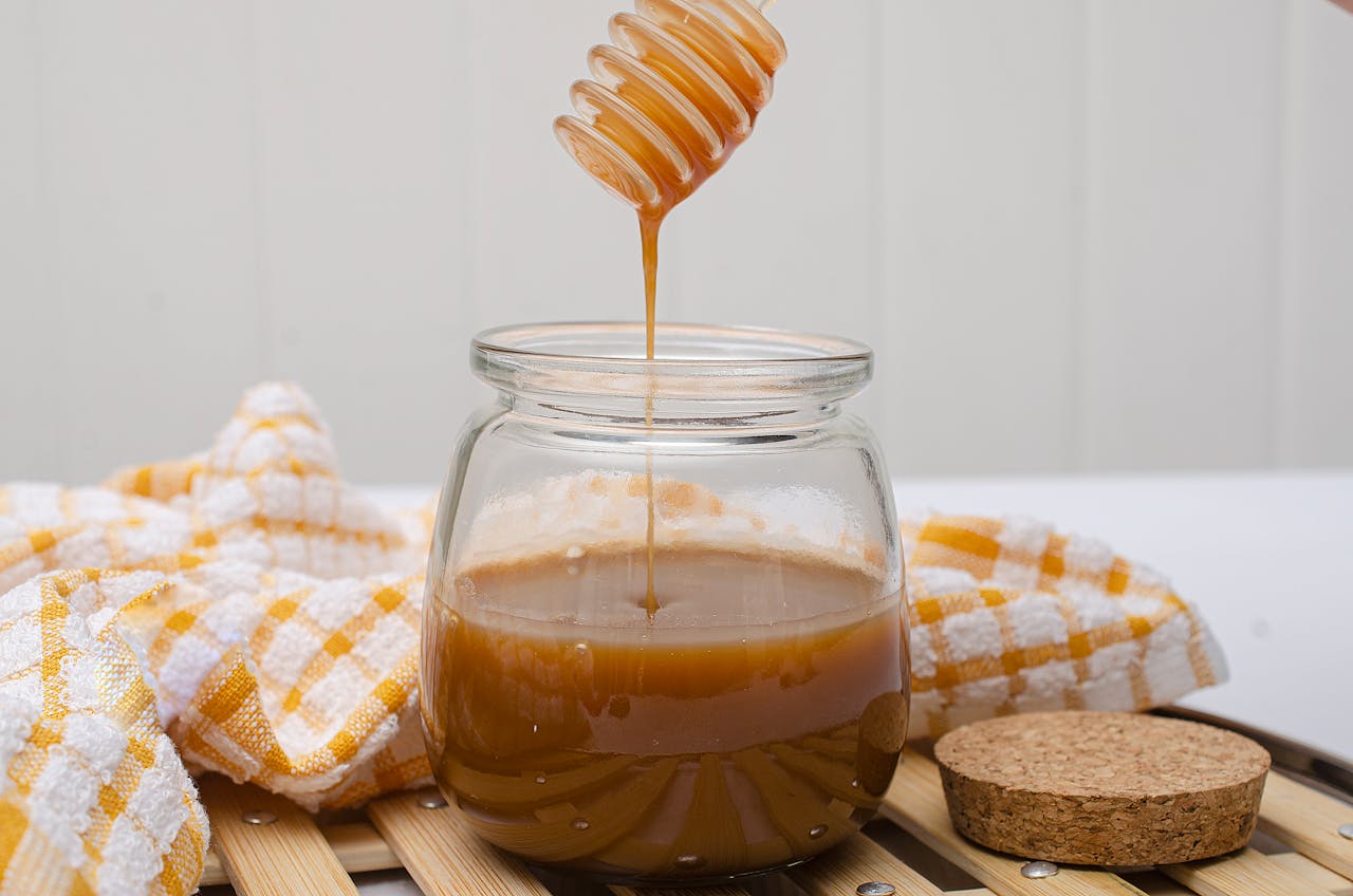 Jar with Honey on a Wooden Surface