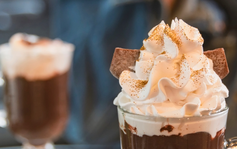 Hot chocolate with whipped cream and golden edible glitter